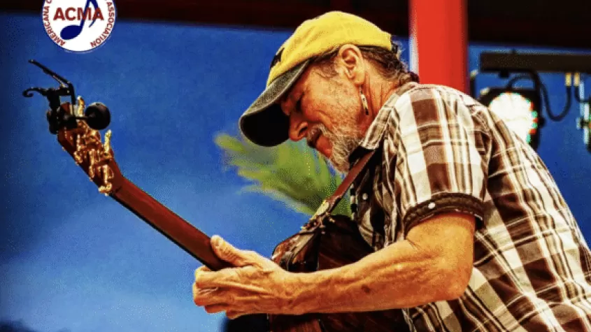 profile view of guitarist Brian Smalley performing