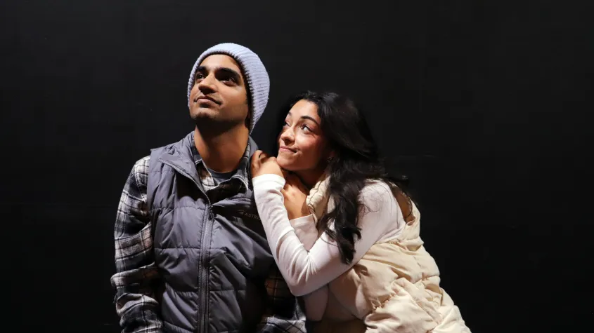 A man and a woman look at the stars
