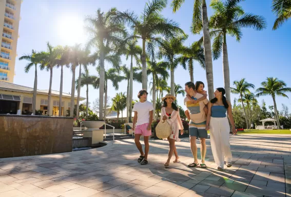 family walking outside at hyatt regency coconut point resort